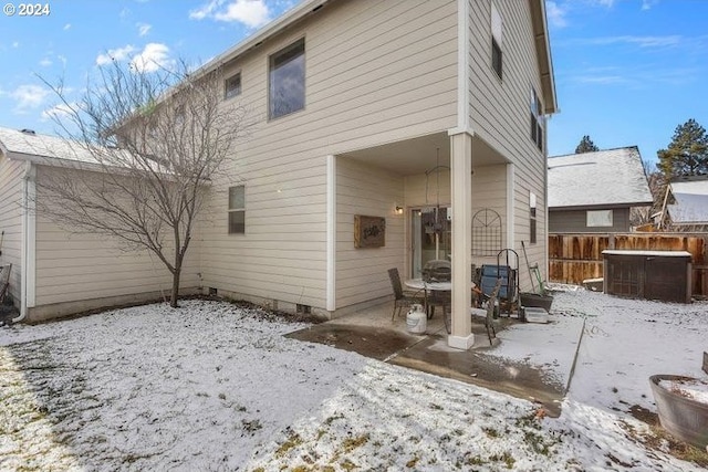 snow covered property featuring central AC