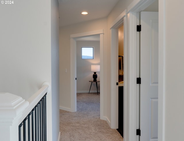 corridor featuring light colored carpet