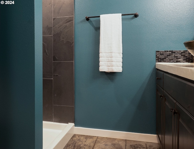 bathroom with vanity and tiled shower