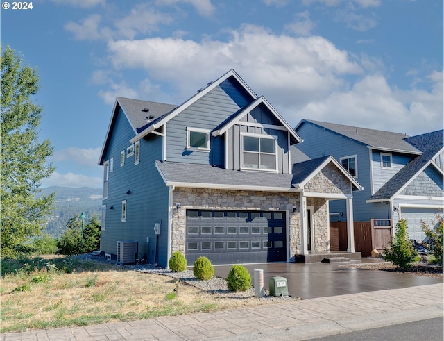 craftsman-style house with a garage and central AC