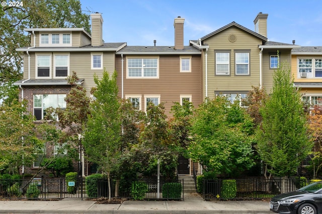 view of front of property featuring a fenced front yard and a chimney