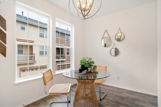 dining room featuring dark wood-type flooring and an inviting chandelier