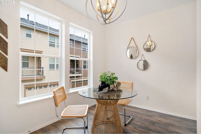 dining area with a notable chandelier, wood finished floors, and baseboards