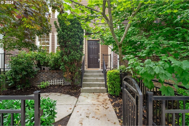 doorway to property with a gate and fence