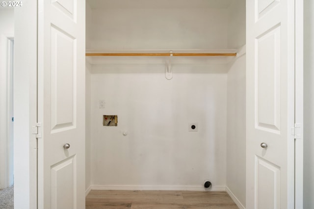 washroom with baseboards, hookup for an electric dryer, laundry area, washer hookup, and light wood-type flooring