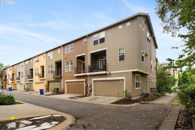 view of property with central AC unit and a garage