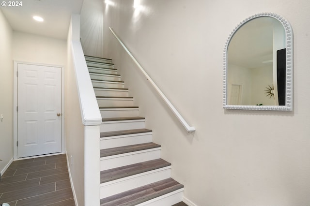 staircase with recessed lighting, baseboards, and wood tiled floor