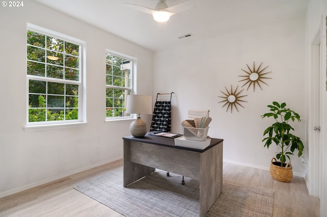 office area with visible vents, a ceiling fan, baseboards, and wood finished floors