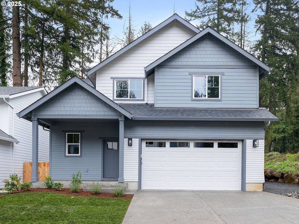 view of front facade with a garage and a front lawn