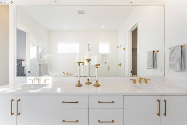 bathroom with a shower with door and vanity