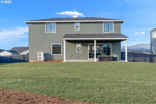 back of property with a patio, ac unit, and a lawn