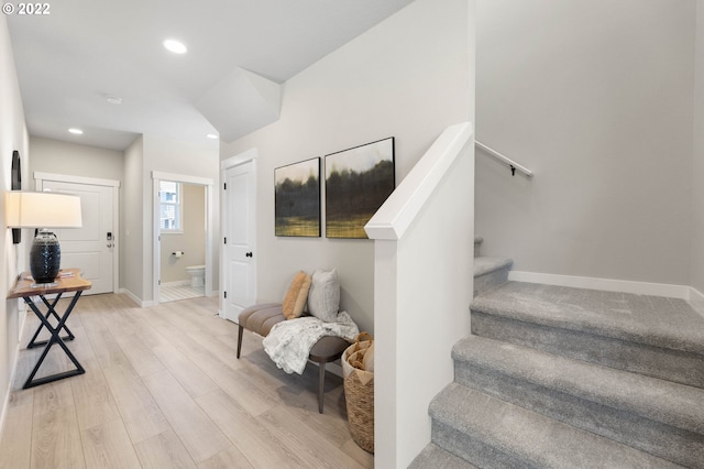 stairway with hardwood / wood-style flooring