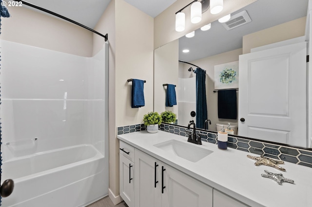 full bathroom with toilet, vanity, and shower / bath combo