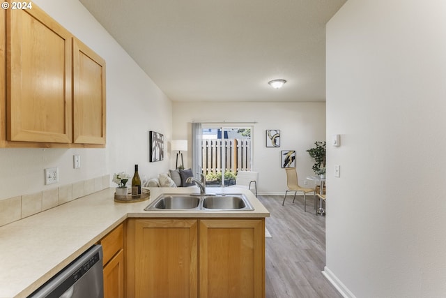 kitchen with sink, light hardwood / wood-style floors, stainless steel dishwasher, kitchen peninsula, and light brown cabinets