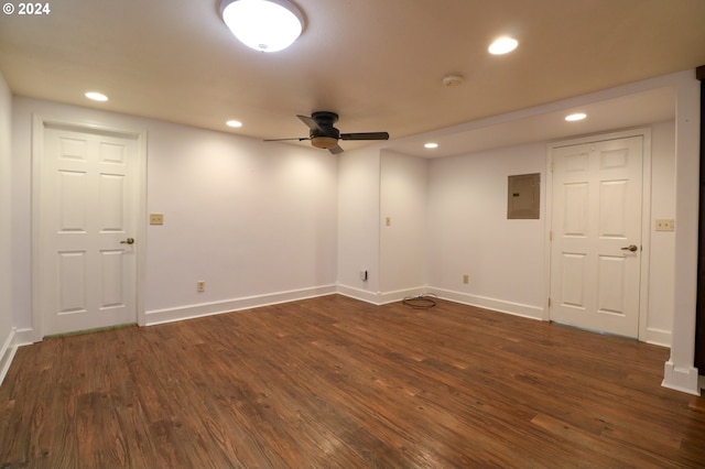 empty room with dark hardwood / wood-style flooring, electric panel, and ceiling fan