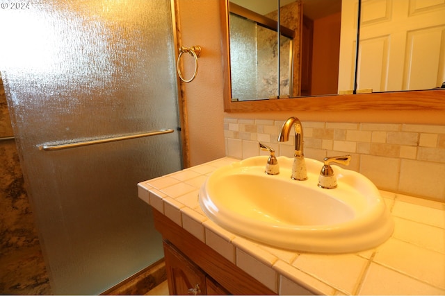 bathroom with tasteful backsplash and vanity