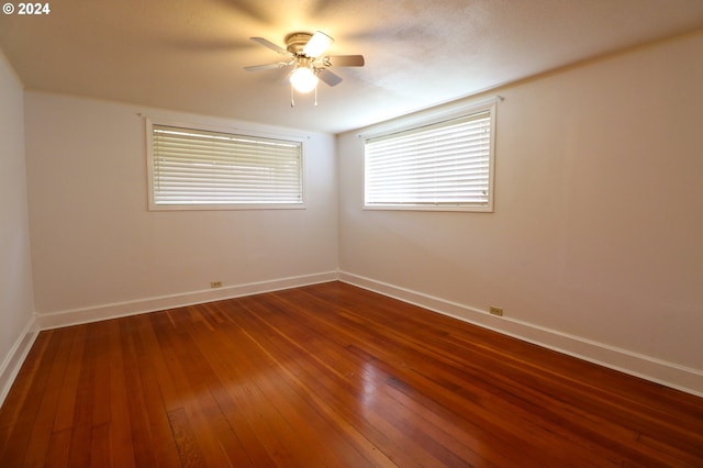 empty room with hardwood / wood-style flooring and ceiling fan