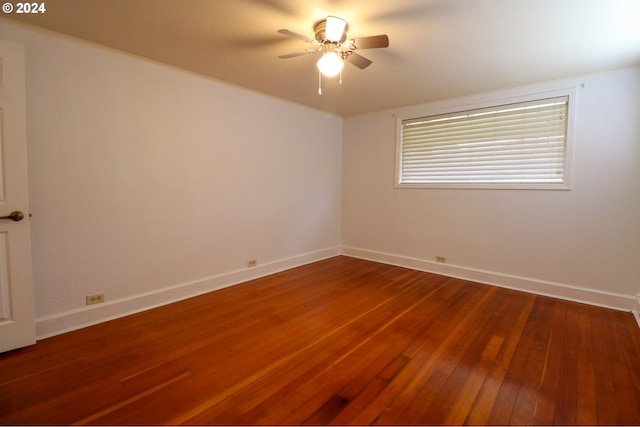 unfurnished room featuring ceiling fan and dark hardwood / wood-style flooring