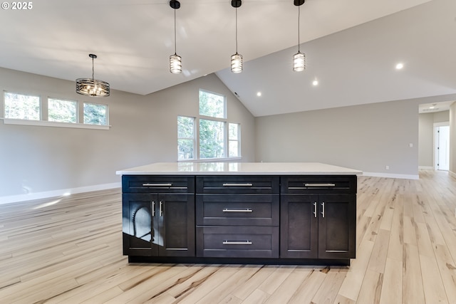 kitchen featuring a kitchen island, light hardwood / wood-style flooring, and hanging light fixtures