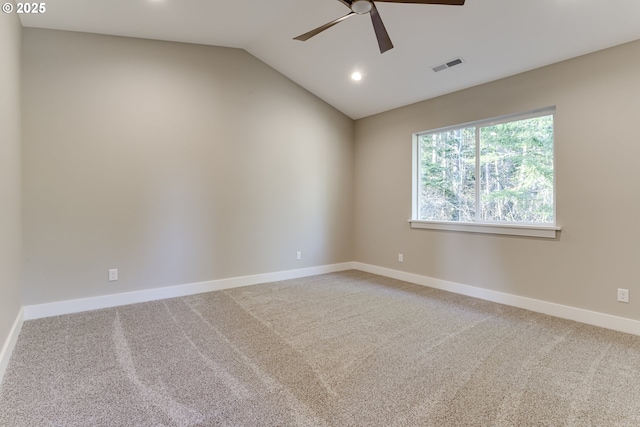 spare room featuring carpet flooring, vaulted ceiling, and ceiling fan