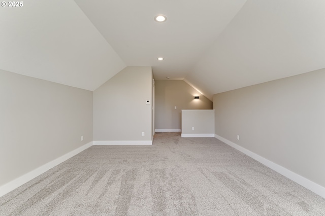 bonus room featuring light colored carpet and vaulted ceiling