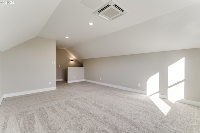 additional living space featuring light carpet and lofted ceiling