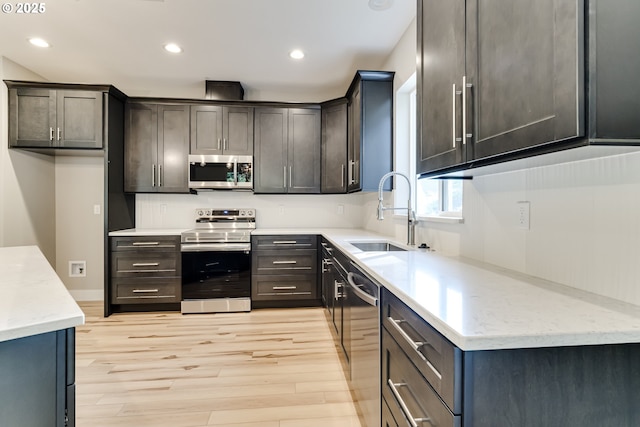 kitchen featuring light hardwood / wood-style floors, sink, and stainless steel appliances