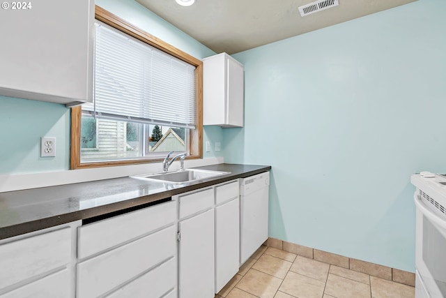 kitchen featuring white appliances, white cabinetry, sink, and light tile patterned floors