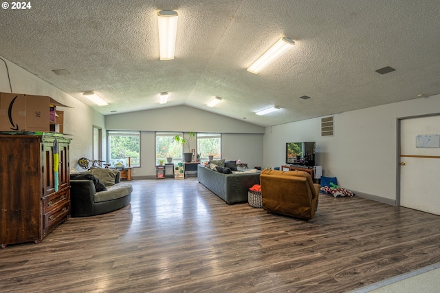 living room with dark hardwood / wood-style flooring, a textured ceiling, and vaulted ceiling