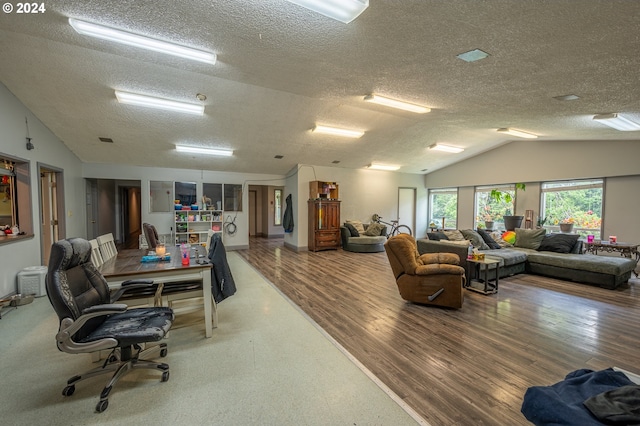 office area with hardwood / wood-style floors, a textured ceiling, and vaulted ceiling