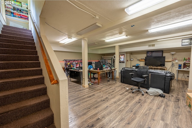 home office with wood-type flooring and a textured ceiling