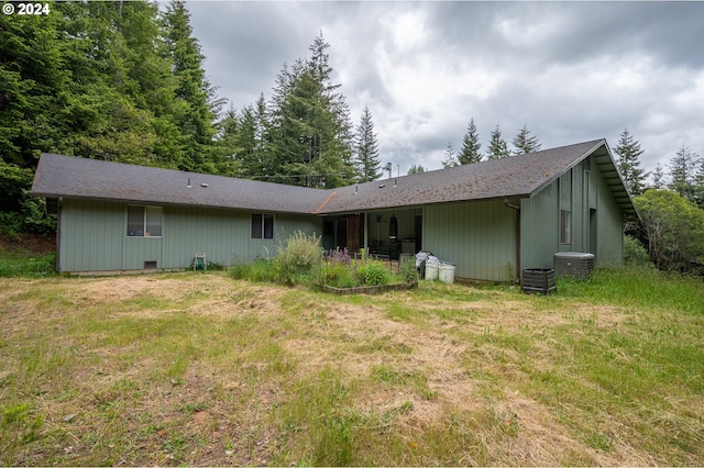 rear view of property with a lawn