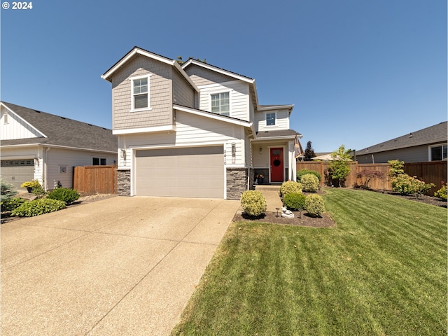 view of front of house with a front lawn and a garage