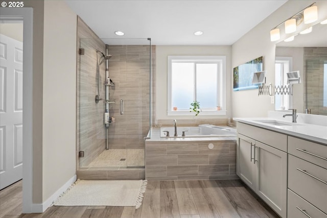 2410 S Heather St, Cornelius, OR 97113 - bathroom featuring a garden tub, a stall shower, vanity, wood finished floors, and recessed lighting