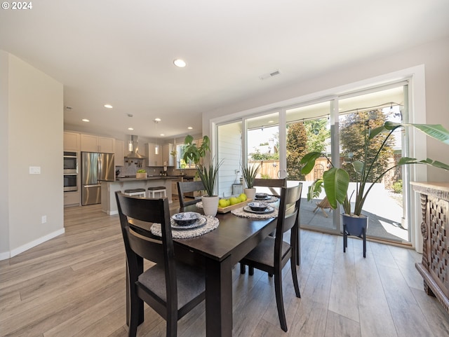 dining space with light hardwood / wood-style flooring