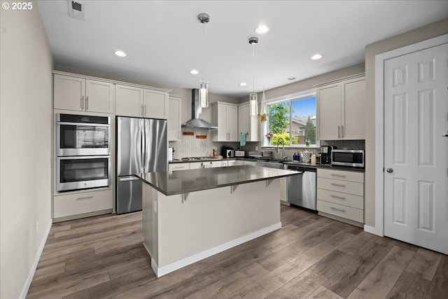 2410 S Heather St, Cornelius, OR 97113 - kitchen featuring stainless steel appliances, wall chimney exhaust hood, dark countertops, a sink, and recessed lighting