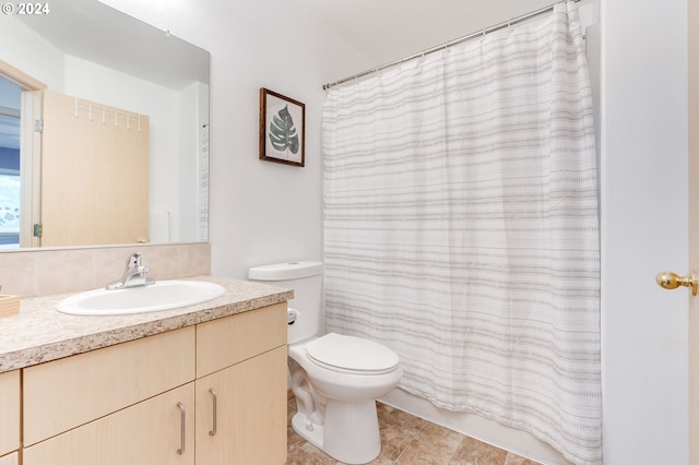 bathroom featuring vanity, toilet, and a shower with shower curtain