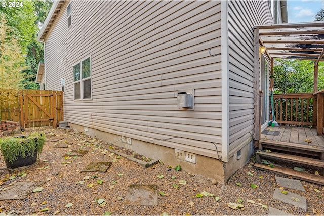 view of property exterior with a deck