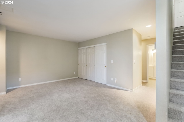 unfurnished bedroom featuring baseboards, carpet, a closet, and recessed lighting