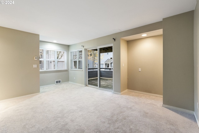 spare room featuring visible vents, recessed lighting, carpet, and baseboards