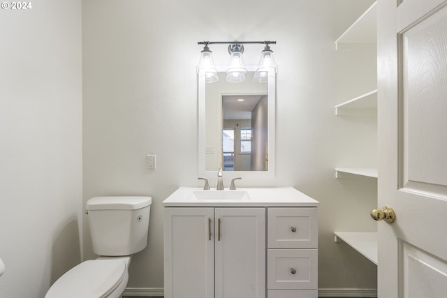half bath featuring toilet and vanity