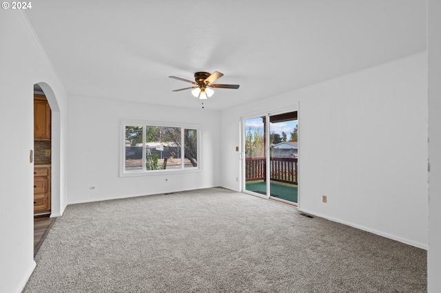 carpeted spare room featuring ceiling fan and ornamental molding