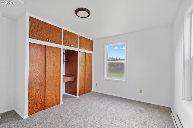 unfurnished bedroom featuring a baseboard radiator and light carpet