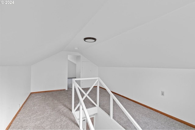 additional living space with lofted ceiling and carpet flooring