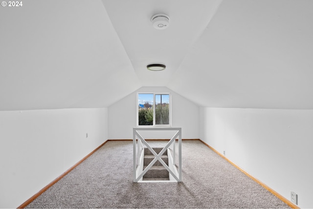 bonus room featuring carpet floors and lofted ceiling