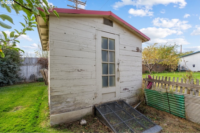 view of outdoor structure with a lawn