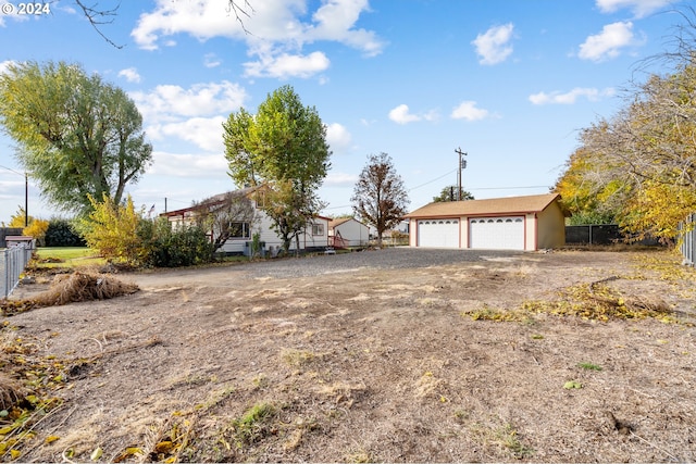 1655 NE 2nd St, Hermiston, OR 97838 - view of front facade with fence, an outbuilding, and a detached garage