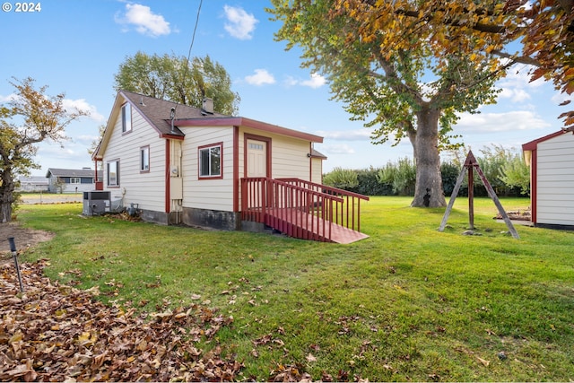 view of side of property with a wooden deck and a yard