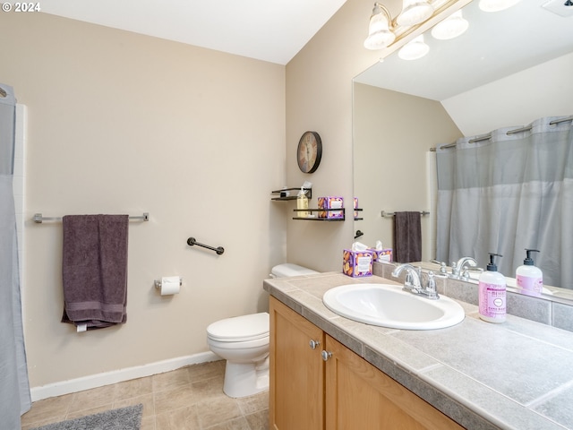 bathroom featuring vanity, toilet, and vaulted ceiling