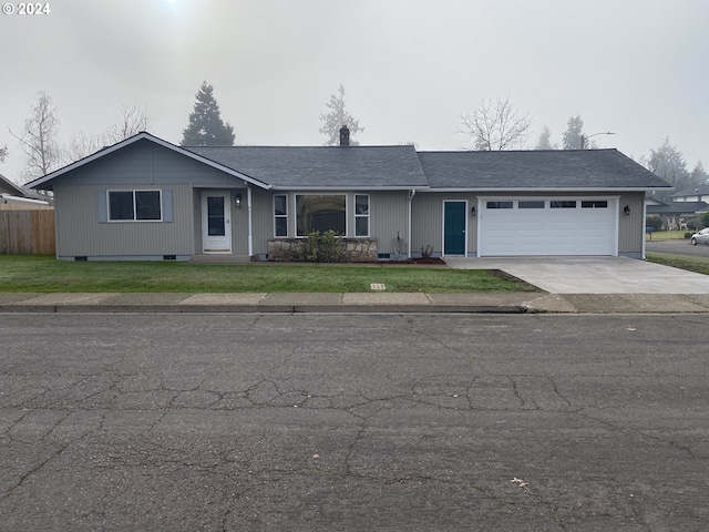 ranch-style house with a garage and a front yard